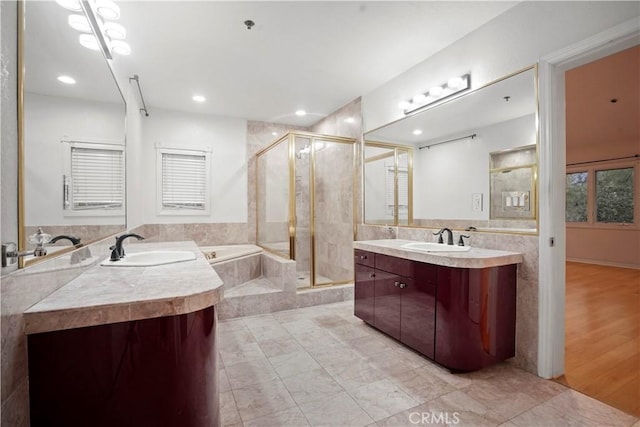 bathroom with vanity, wood-type flooring, and independent shower and bath