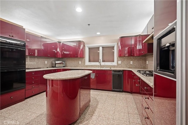 kitchen featuring decorative backsplash, a center island, sink, and black double oven