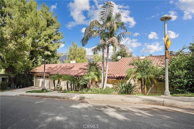 mediterranean / spanish-style house with a garage