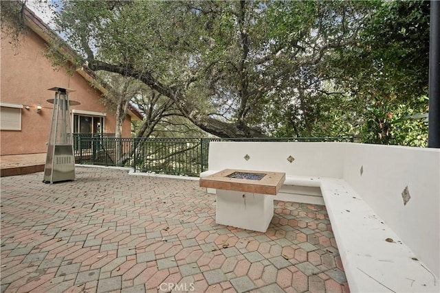 view of patio / terrace featuring an outdoor fire pit