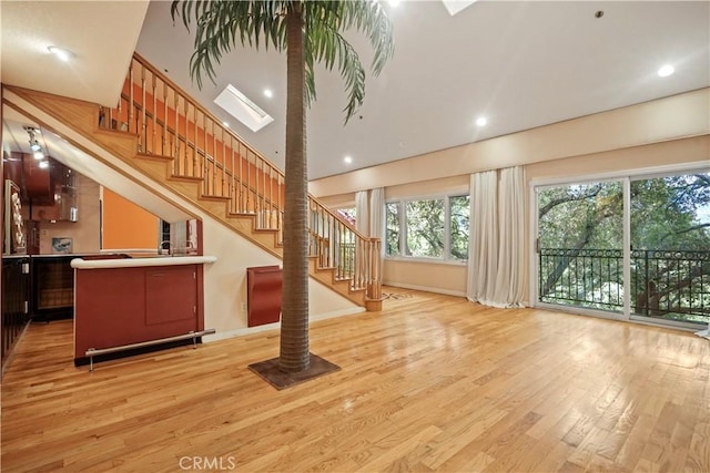 interior space with light wood-type flooring and a skylight