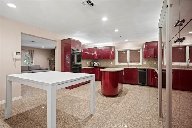 kitchen with backsplash, sink, and a kitchen island