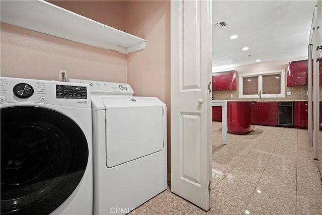 clothes washing area with washing machine and clothes dryer