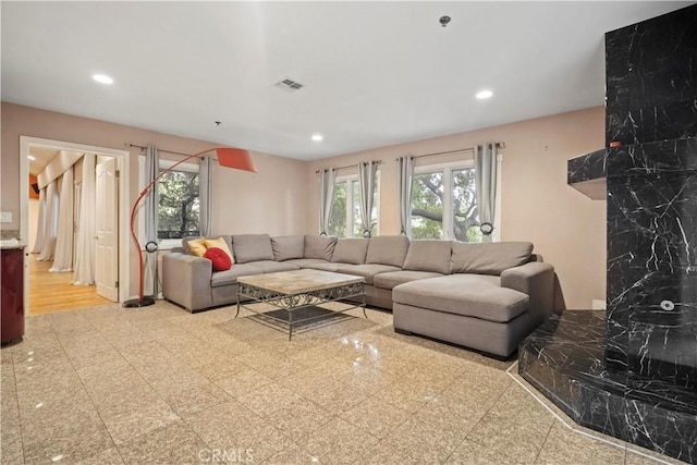 living room with light hardwood / wood-style flooring and tile walls