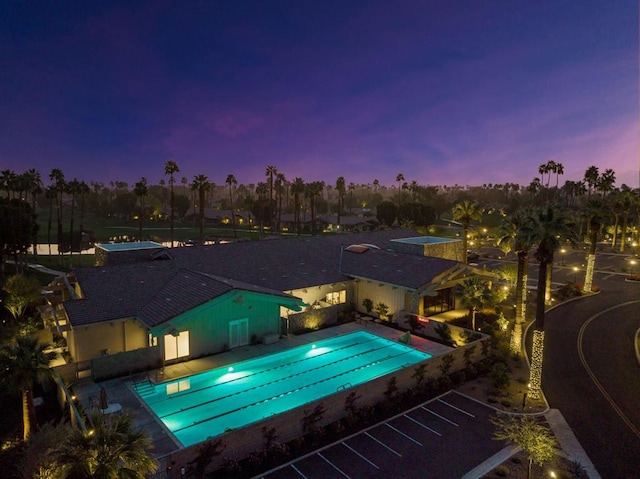 view of pool at dusk