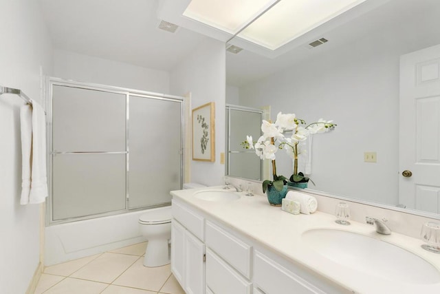 full bathroom with tile patterned flooring, vanity, toilet, and enclosed tub / shower combo