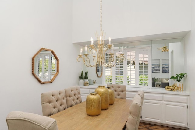 dining space with ceiling fan with notable chandelier