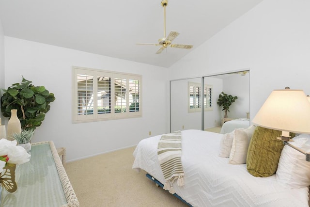 carpeted bedroom featuring a closet, high vaulted ceiling, and ceiling fan