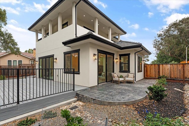 rear view of house featuring outdoor lounge area and a patio