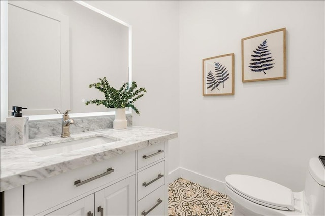 bathroom with tile patterned floors, vanity, and toilet