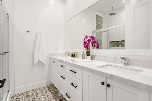 bathroom featuring tile patterned flooring, vanity, and a shower with shower door