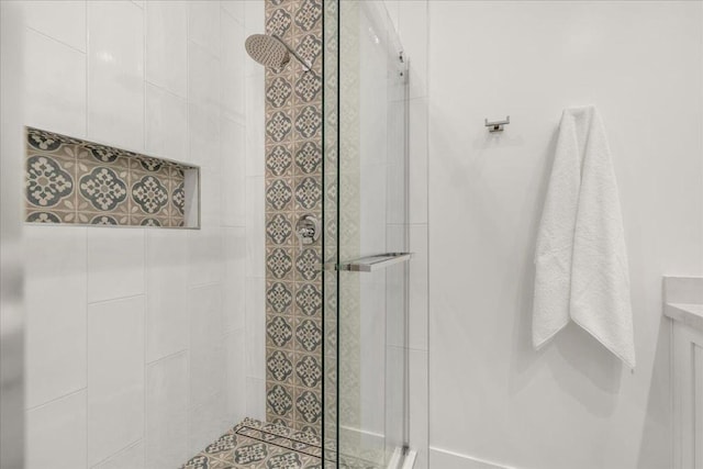 bathroom with vanity and tiled shower