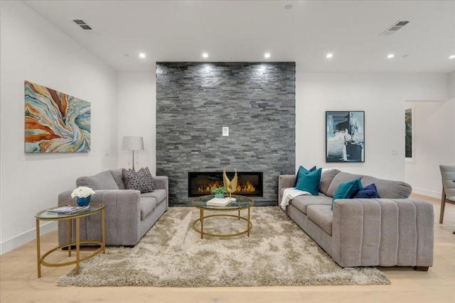 living room with a fireplace and light hardwood / wood-style flooring