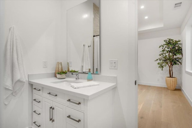 bathroom with vanity and wood-type flooring