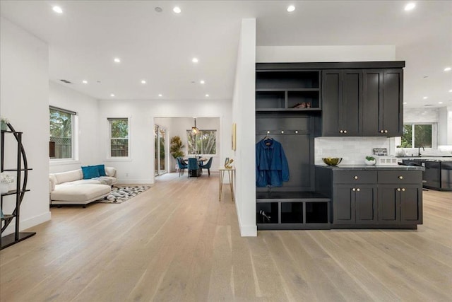 interior space with decorative backsplash and light wood-type flooring