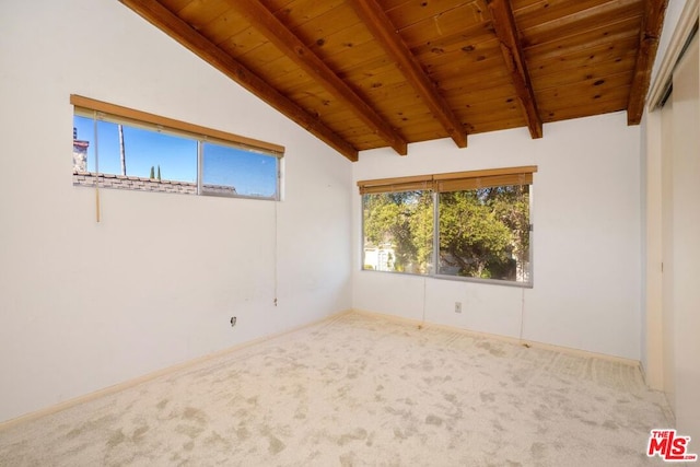 carpeted empty room featuring vaulted ceiling with beams and wood ceiling