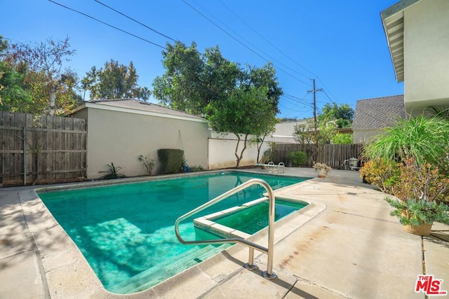 view of pool featuring a patio and a hot tub