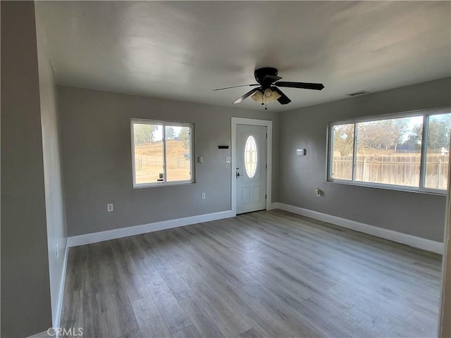 foyer entrance featuring ceiling fan and light wood-type flooring