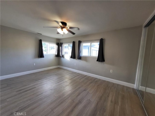 empty room featuring hardwood / wood-style floors and ceiling fan