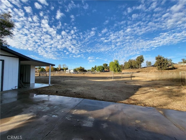 view of yard featuring a patio area and a rural view