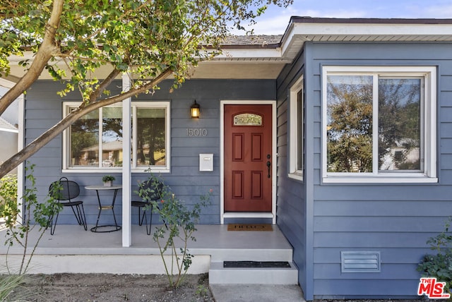 doorway to property featuring a porch