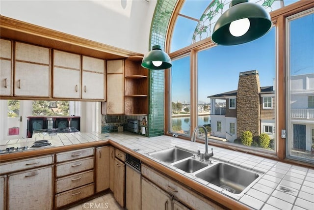 kitchen featuring tile countertops and a healthy amount of sunlight