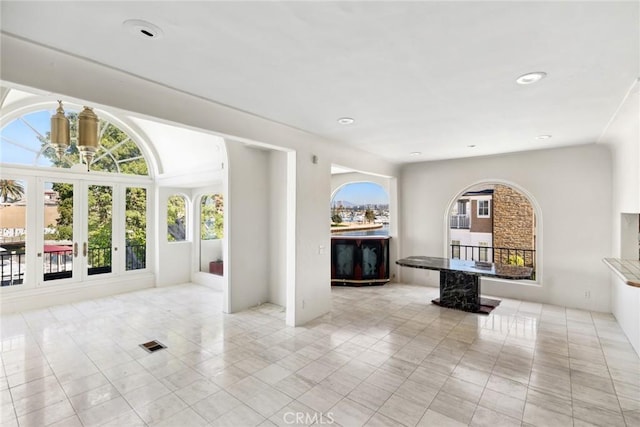 interior space with french doors, light tile patterned floors, and a healthy amount of sunlight