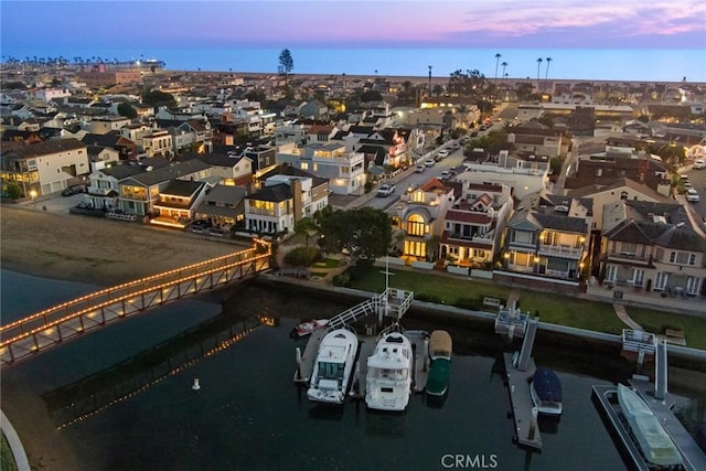 aerial view at dusk with a water view