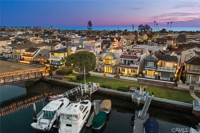 aerial view at dusk with a water view