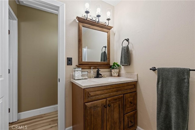 bathroom with vanity and hardwood / wood-style floors