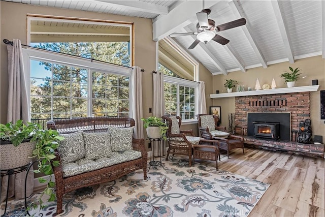 sunroom / solarium with ceiling fan and vaulted ceiling with beams