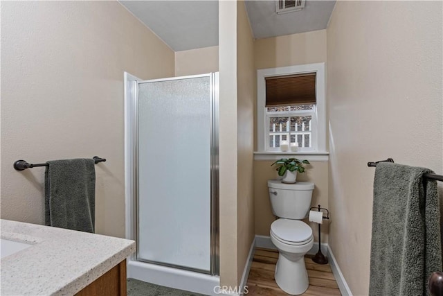 bathroom with vanity, an enclosed shower, hardwood / wood-style floors, and toilet