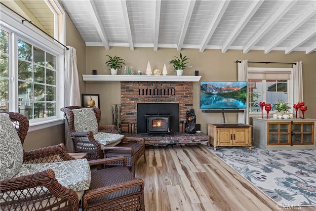 living area featuring beamed ceiling and hardwood / wood-style flooring