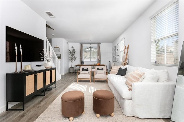 living room featuring a chandelier and wood-type flooring