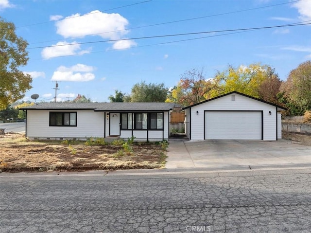 single story home featuring an outbuilding and a garage