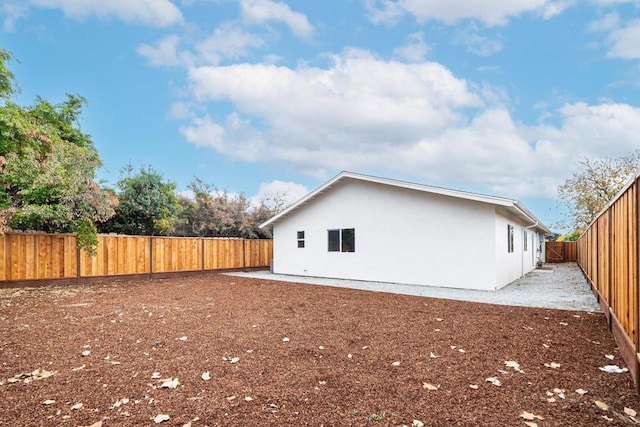 view of side of property featuring a patio area