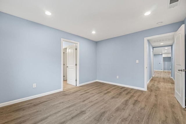 empty room with light hardwood / wood-style flooring