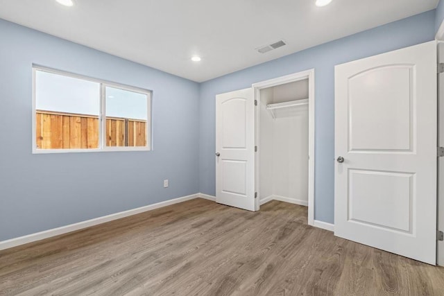 unfurnished bedroom featuring a closet and light hardwood / wood-style flooring