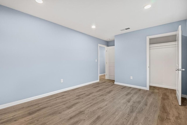 unfurnished bedroom featuring a closet and light hardwood / wood-style flooring