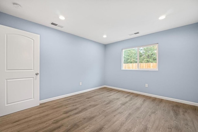 spare room with light hardwood / wood-style floors