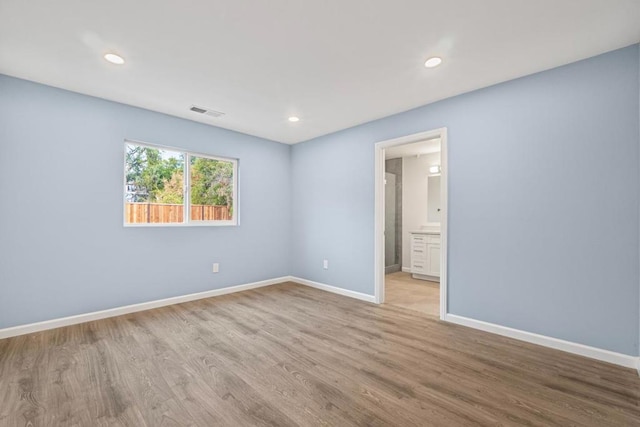 spare room featuring light hardwood / wood-style floors