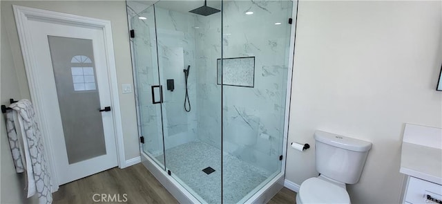 bathroom with hardwood / wood-style floors, toilet, and walk in shower