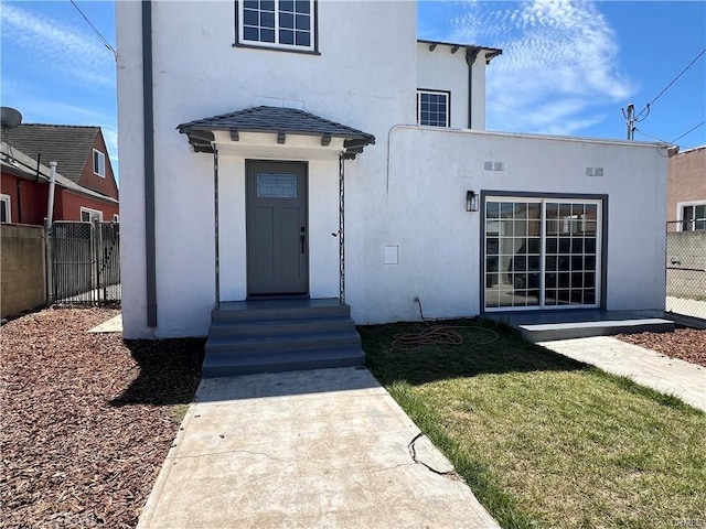 doorway to property with a yard