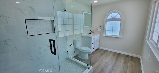 bathroom with vanity, hardwood / wood-style flooring, toilet, and a shower with door