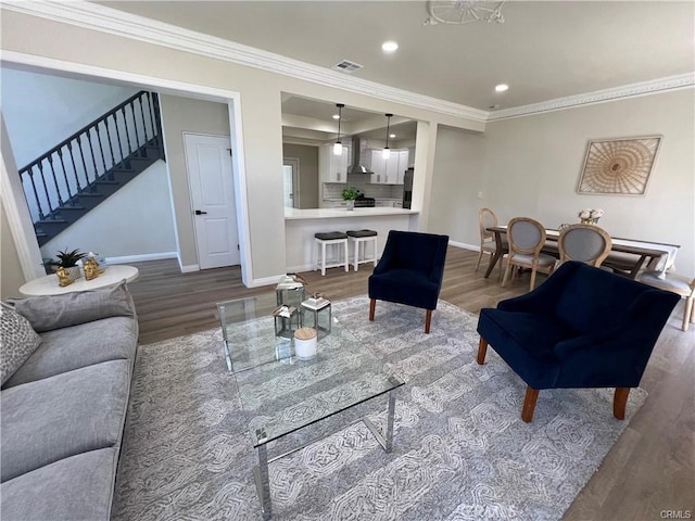 living room featuring hardwood / wood-style flooring and crown molding