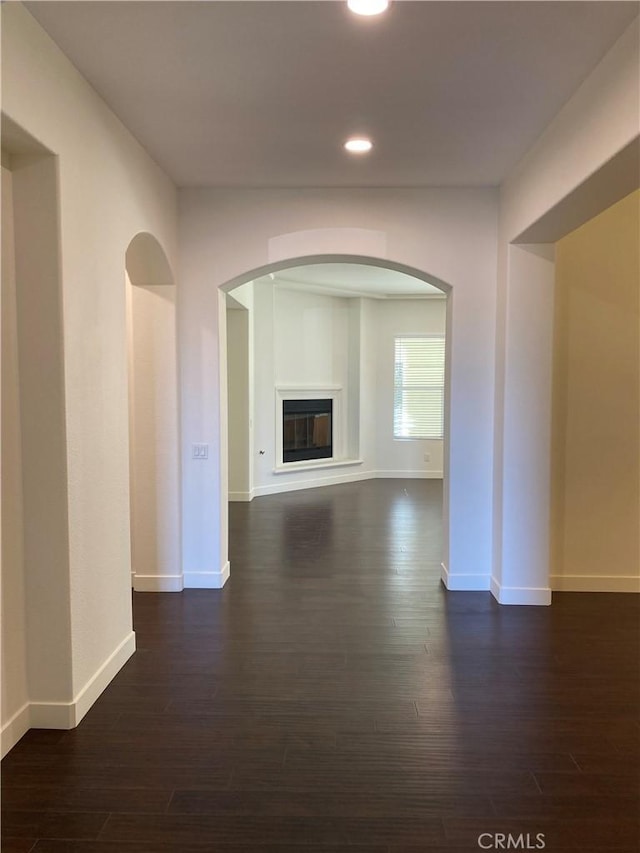 unfurnished living room featuring dark hardwood / wood-style flooring