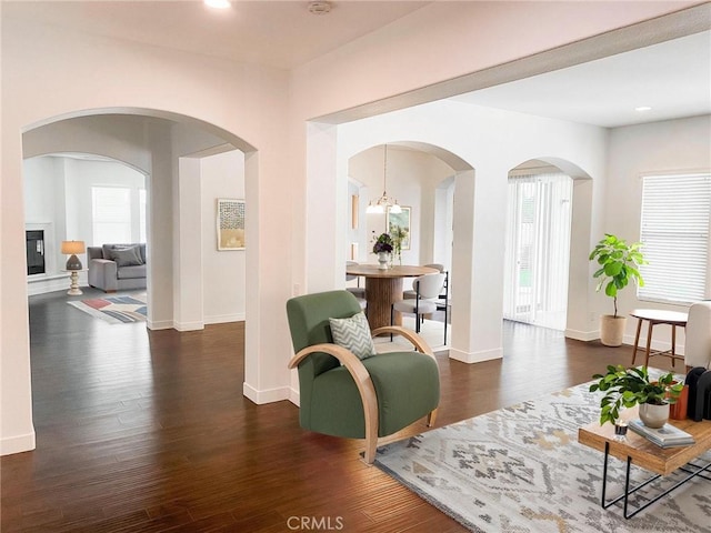 sitting room featuring dark hardwood / wood-style floors and a chandelier