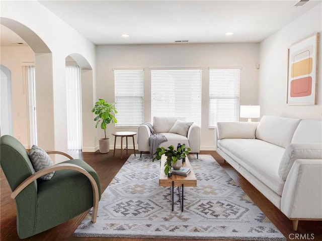 living room with dark hardwood / wood-style floors