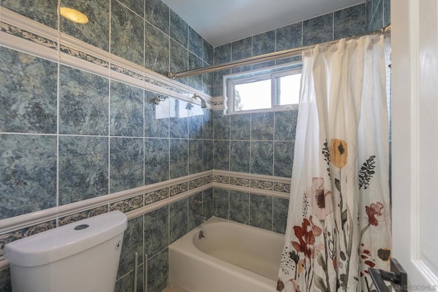 bathroom with toilet, tile walls, and shower / bathtub combination with curtain