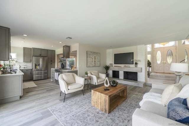 living room featuring a fireplace and light hardwood / wood-style floors